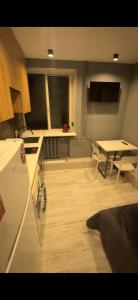 a kitchen with a counter and a table in a room at TopApartment 1 in Sumy