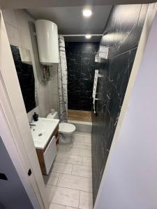 a bathroom with a white toilet and a sink at TopApartment 1 in Sumy
