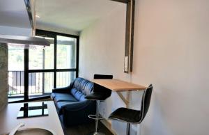 a living room with a blue couch and a table at Studio, centre La Bresse in La Bresse +1 photo