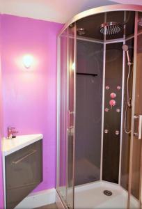 a bathroom with a shower with purple walls and a sink at Studio, centre La Bresse in La Bresse