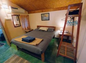 a bedroom with a bunk bed and a ladder at BRAMHA COTTAGES in Canacona