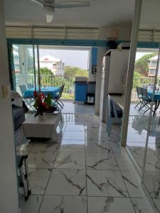 a view of a living room with a tile floor at Le CATALEYHA in Le Moule