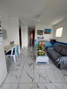 a living room with a couch and a table at Le CATALEYHA in Le Moule