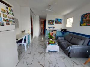 a living room with a couch and a table at Le CATALEYHA in Le Moule