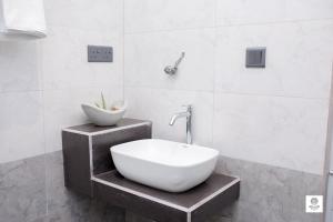 a bathroom with a sink and a bowl on a shelf at Willow Waters in Galle +11 photos