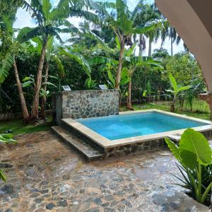 a swimming pool in a yard with trees at Casa los Mangos Private pool 150 m from the beach in Las Galeras