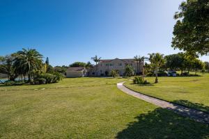 a house with a walkway in front of a yard at Flanders South Cottage in Gqeberha