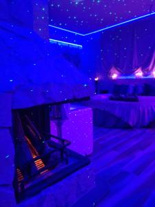 a room with a fireplace in a room with purple lights at Tecaia Secret Luxury Suite in Formia