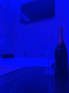 a blue room with a bottle and a wine glass at Tecaia Secret Luxury Suite in Formia