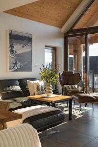 a living room with a couch and a table and chairs at APARTAMENT No1 MOUNTAIN VIEW Sauna Priv okolice Zakopane Czorsztyn Kluszkowce in Kluszkowce
