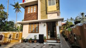 a house with a lot of plants in front of it at Gypsy Walker in Varkala