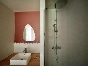 a bathroom with a sink and a shower with a mirror at L'Échappée Boisée - côté Vallée in Chambon-sur-Cisse +4 photos