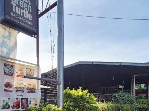 a sign for a fast food restaurant in front of a building at Green Turtle Backpackers Guesthouse, Puerto Princesa in Puerto Princesa City +1 photo