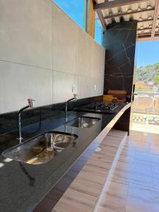 een aanrecht met een wastafel en een fornuis bij Hotel Grutta in Bom Jesus da Lapa