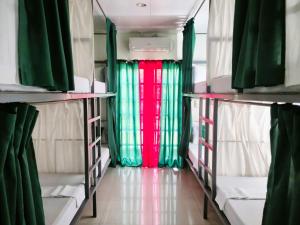 a room with a red and green curtain in an rv at Green Turtle Backpackers Guesthouse, Puerto Princesa in Puerto Princesa City