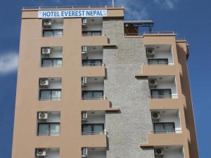 a tall apartment building with a hotel everwegian needle sign on it at Hotel Everest Nepal in Kathmandu