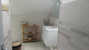 a white bathroom with a sink and a counter at VILLARGONDRAN vélos en Maurienne garage in Villargondran