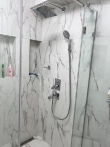 a bathroom with a shower with a glass door at Апартаменты in Izmail