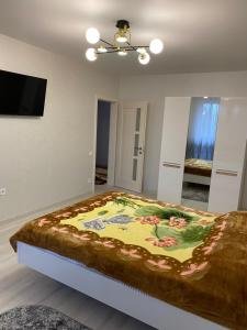 a bedroom with a large bed with avertisementatronatronstrationstration at Апартаменты in Izmail