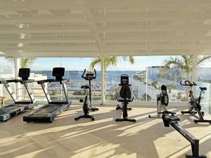a gym with treadmills and cardio equipment in a building at Prince Delmar Waterfront Olhao by Junto ao Mar in Olhão