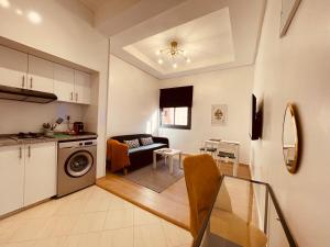 a kitchen and living room with a washer and dryer at ZyonFamily in Ouarzazate