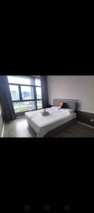 a bedroom with a bed and a large window at Millerz Square block C in Kuala Lumpur