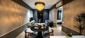 a dining room with a table and chairs and a chandelier at Millerz Square block C in Kuala Lumpur