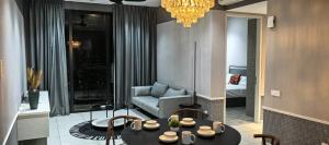 a living room with a table and a couch at Millerz Square block C in Kuala Lumpur