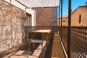 einen Tisch auf einem Balkon mit einem Zaun in der Unterkunft Casa súper acollidora completament reformada in Saldet