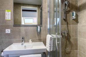 a bathroom with a sink and a shower at Hôtel le Saint Nicolas in Riquewihr +106 photos
