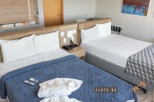 En eller flere senge i et værelse på Paiva Flats By Loui