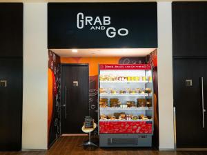 a grocery store with a cart and go refrigerator at ibis Dubai One Central in Dubai