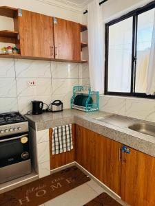 a kitchen with a stove and a sink at Casses Apartments in Mombasa