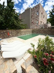 a swimming pool with a toilet in front of a building at Terra Malal in Chos Malal