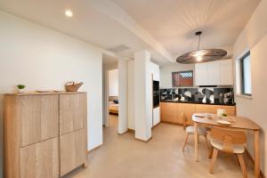 a kitchen and dining room with a table and chairs at Casa Ponente in Porto Santo Stefano