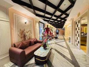 a living room with a couch and a table at The Sterling Resort in Bhawānīgarh
