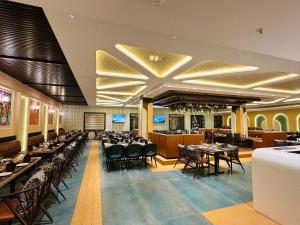 a dining room with tables and chairs in it at The Sterling Resort in Bhawānīgarh