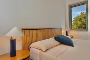 a bedroom with a bed with a table and a window at Casa Ponente in Porto Santo Stefano