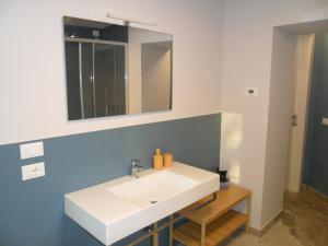 a bathroom with a white sink and a mirror at Carme31 Sirmione in San Martino della Battaglia