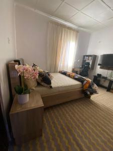 a bedroom with a large bed with flowers on it at The Flamingo 2 in Jos