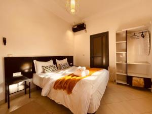 a bedroom with a bed with a teddy bear on it at ZyonFamily in Ouarzazate