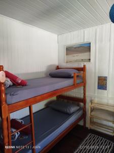 En eller flere senge i et værelse på Cabanas LA CASITA BRISA DO MAR