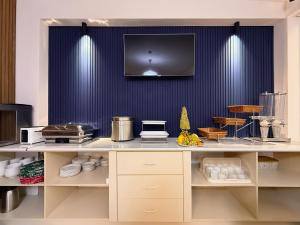 a kitchen with a counter with a blue wall at Musafir Hotel in Tashkent
