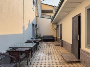 an empty corridor with tables and chairs in a building at Musafir Hotel in Tashkent