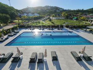 an overhead view of a swimming pool with lounge chairs at Luxury Waterfront Villa 431F Starlink Wifi in Jolly Harbour