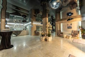 a large room with a lobby with tables and chairs at Stillaterm SPA in Mineralni Bani