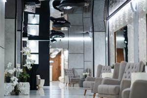 a lobby with chairs and shoes on the wall at Stillaterm SPA in Mineralni Bani