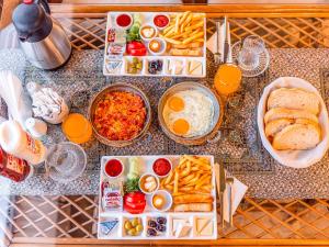 a table with plates of food and eggs and bread at Cappanar Cave in Nar +27 photos