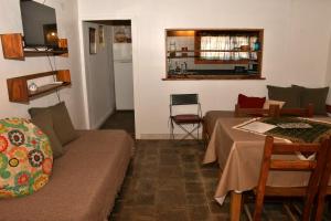 a living room with a couch and a table at Girgola hospedaje in Villa Pehuenia