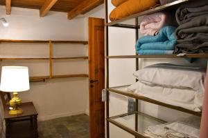 a room with shelves with towels and a lamp at Girgola hospedaje in Villa Pehuenia